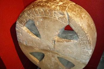 Fragment kamenného kříže z počátku 10. stol. Nápis na kameni zní „Thelvas nechal tento kámen vztyčit na tomto místě”. (© Pavel Semple 11/2017)