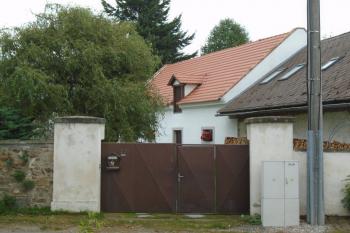 vjezdová vrata do areálu fary na západní straně, vpozadí bývalé hospodářské budovy (© Jaroslav Špiroch  09/2022)