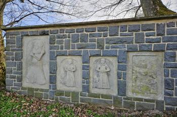kmenná zeď s osazenými kamennými staršími náhrobky (© Jan P. Štěpánek  04/2024)