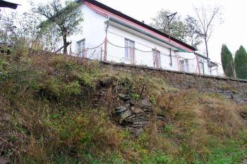 Zdivo neznámého stáří (v popředí), uváděné jako možný pozůstatek hrazení na východní straně ( © Roman Řezáč 10/2004)