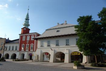Červená budova staré radnice a vpravo od ní Dům U mouřenína s podloubím ( © Roman Řezáč 08/2005)