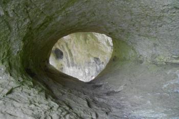 v průřezu kruhoá dutina nad přírodní skalní bránou, s vysekanými kapsami, které se však nedají často zařadit, ale výhled k potoku je odsud dokonalý (© Jan Večeřa, 12/2015)