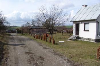 Pohled od východu, mezi kůlnou a domkem se rýsuje jádro tvrze ( © Roman Řezáč 02/2009)