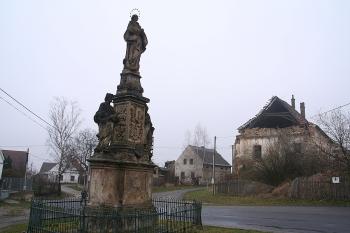 Sloup od jihovýchodu, vpravo v pozadí zřícenina místního zámku (© Ivan Grisa, 03/2009)